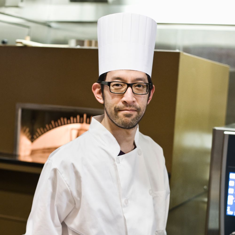 an asian chef working with a roasting pan of mushr hcsqdhc.jpg
